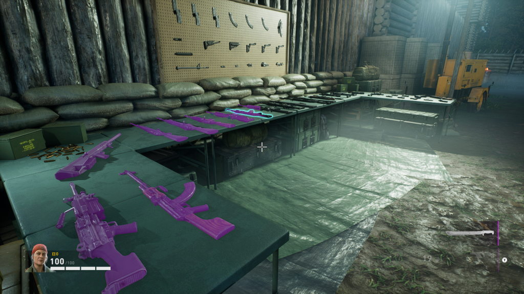Image description: A wide arsenal of weapons are displayed upon a number of pop-up tables and a display board hanging on a rickety wooden fence. Tarps cover the ground nearby whilst a generator and some fortifications stand in the distance.